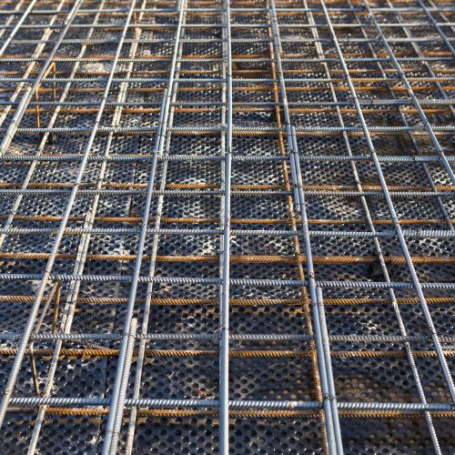 Iron fittings on a wooden blind area with laid pipes are the basis for pouring the foundation Iron fittings on a wooden blind area with laid pipes are the basis for pouring the foundation