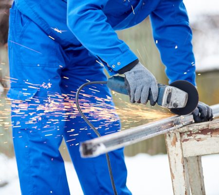 Professional constructionist cutting steel outdoors